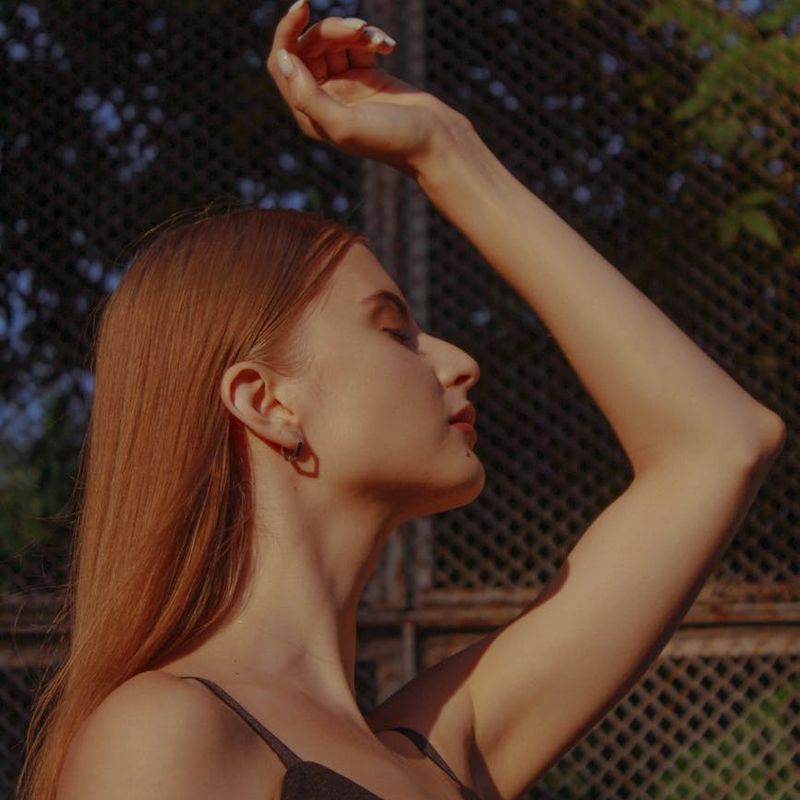 A person in a meditative pose in a bright, spacious studio.