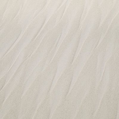 Sand patterns on a beach, representing natural rhythm.